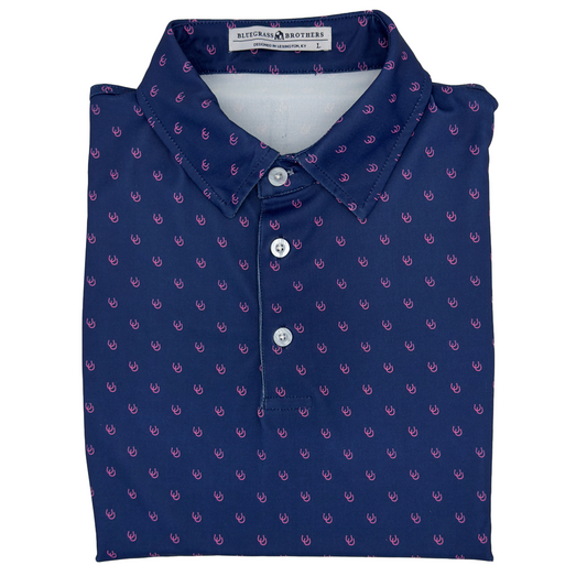 Folded navy blue polo shirt with pink pattern on a white background
